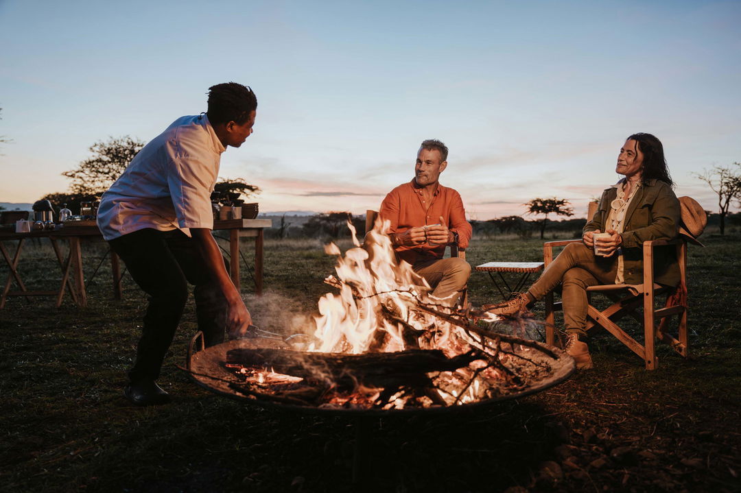 staff making fire in the pit by Wilderness Usawa tented camp Serengeti for two guests