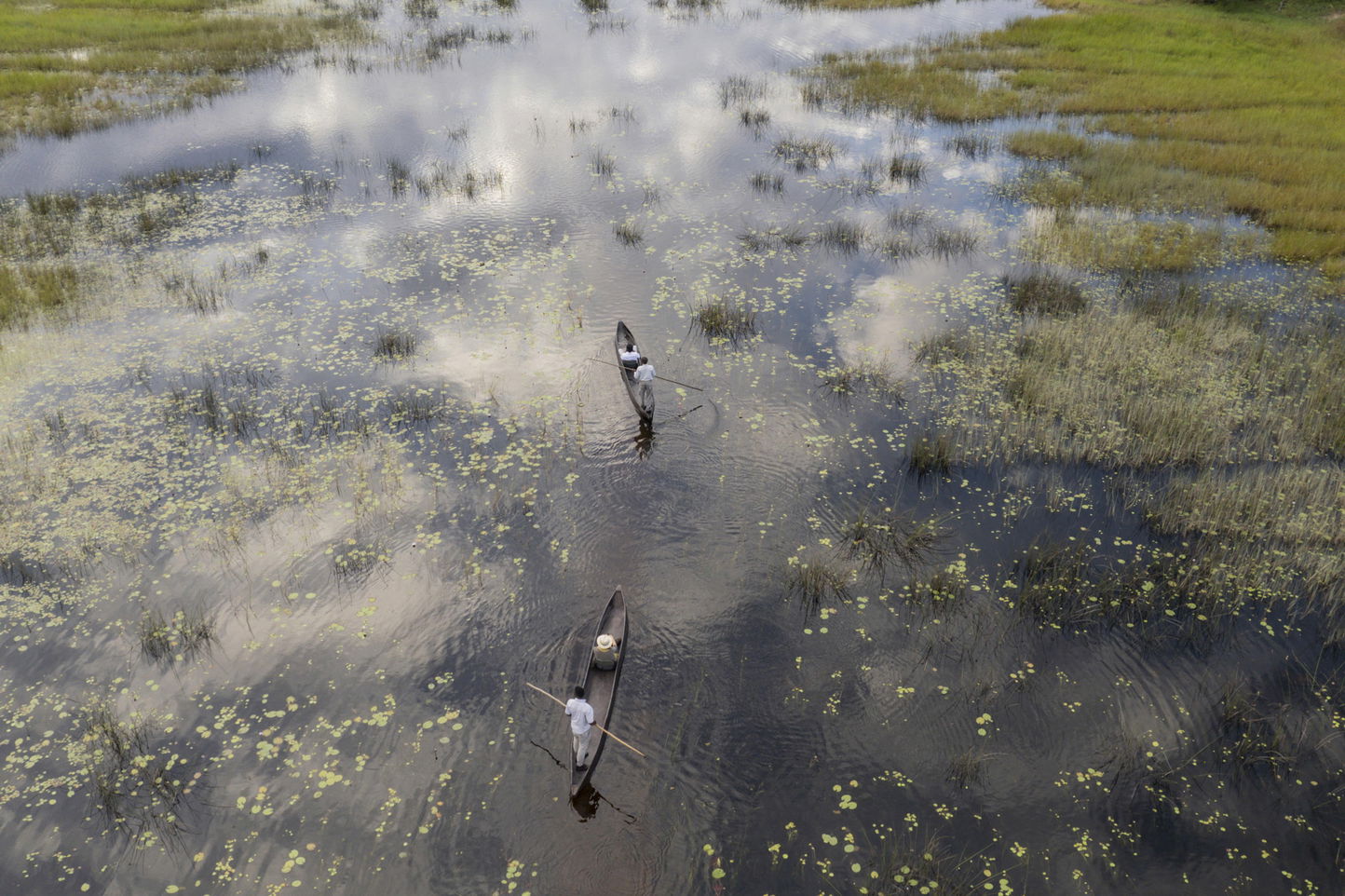 aerial view of two mokoros on water at Vumbura Plains Camp Wilderness Botswana Okavango Delta