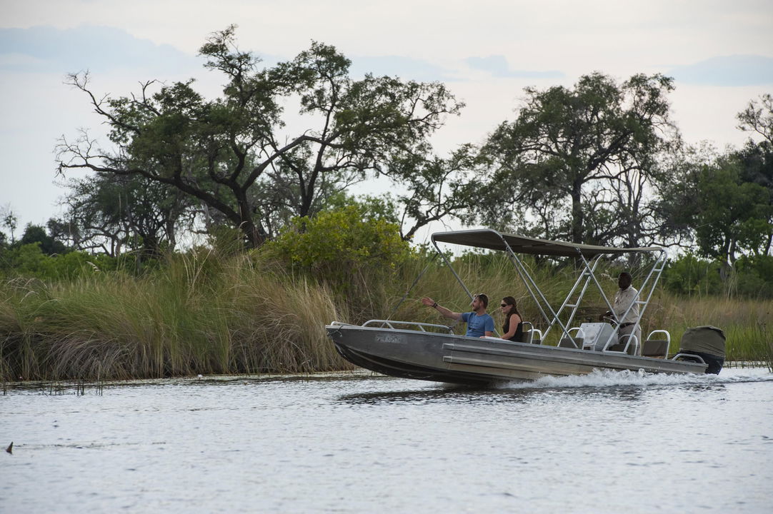 motorboat cruising on waterways of delta at Vumbura Plains Camp Wilderness Okavango Delta