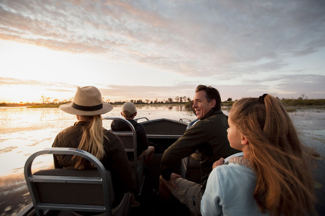 guests on motorboat at Vumbura Plains Camp Wilderness Okavango Delta