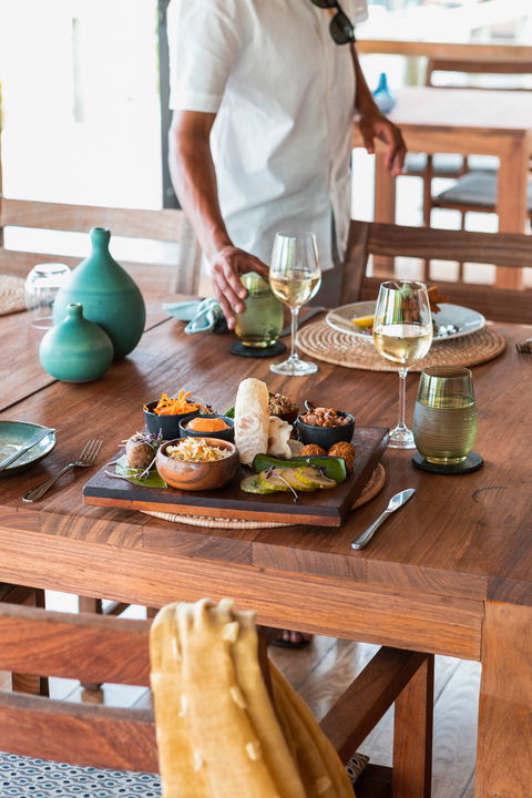 plates with food on table at Vumbura Plains Camp Wilderness Okavango Delta