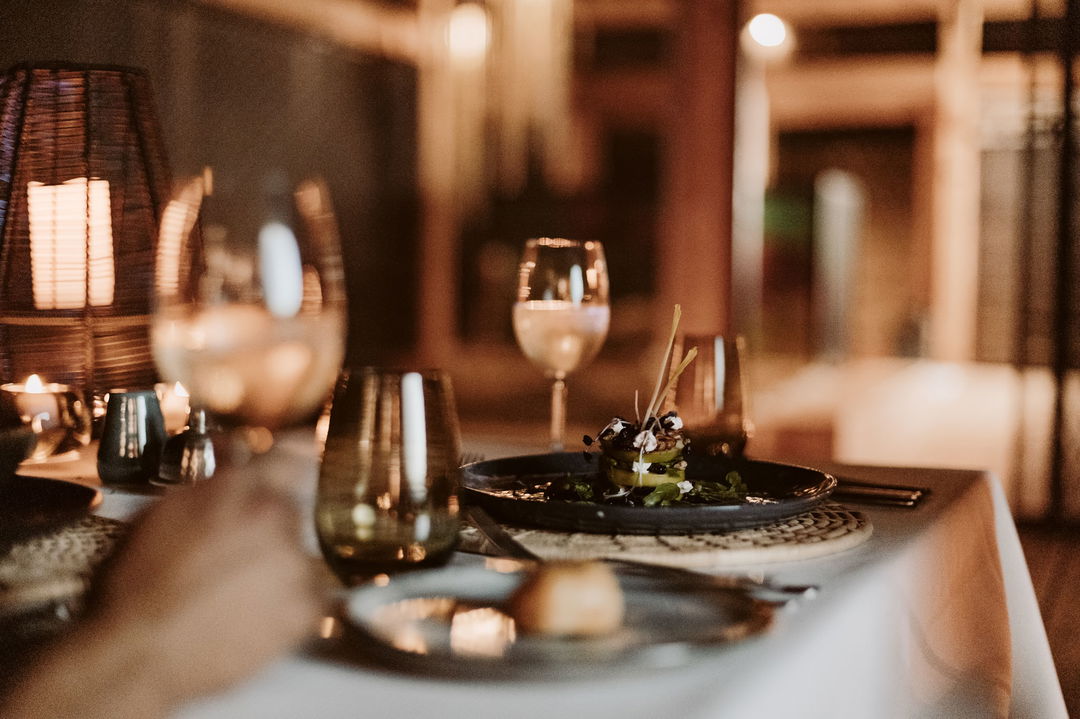 cosine served on table with wine at Vumbura Plains Camp Wilderness Okavango Delta