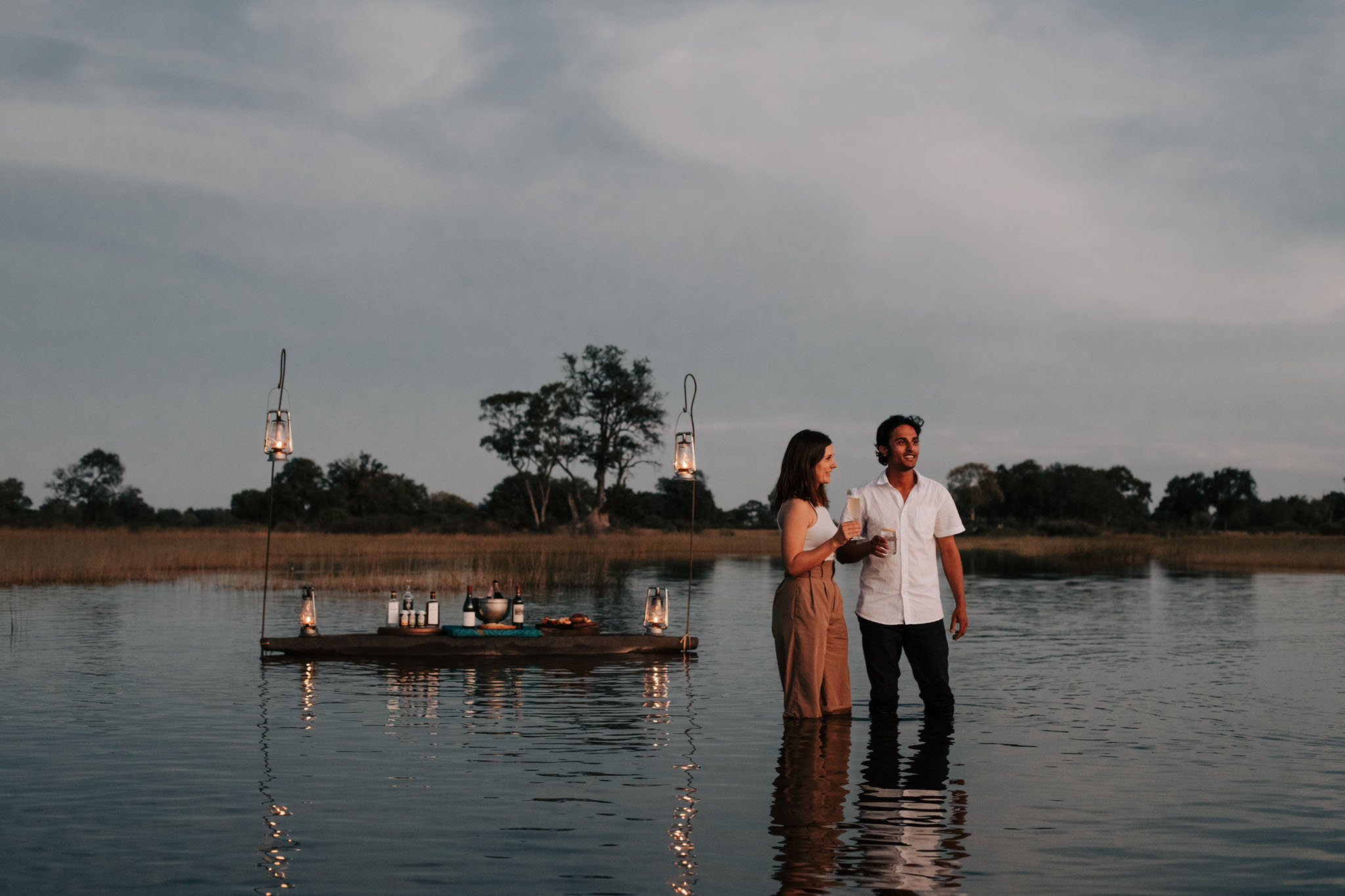 couple in water at vumbura plains on a romantic dinner