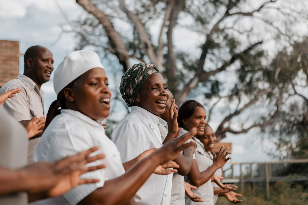 kitchen staff singing to guests at Vumbura Plains Camp Wilderness Botswana Okavango Delta
