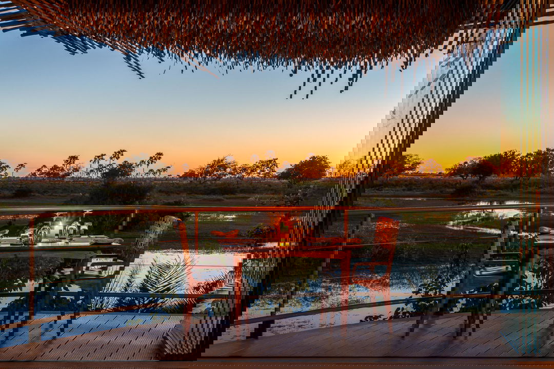 table set for romantic dinner with sunset view of Okavango delta at Jao Camp Botswana