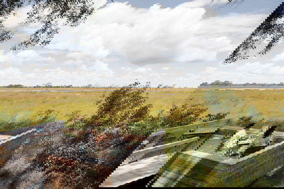 guest having private meal on viewing deck of room at Vumbura Plains Camp Wilderness Botswana Okavango Delta