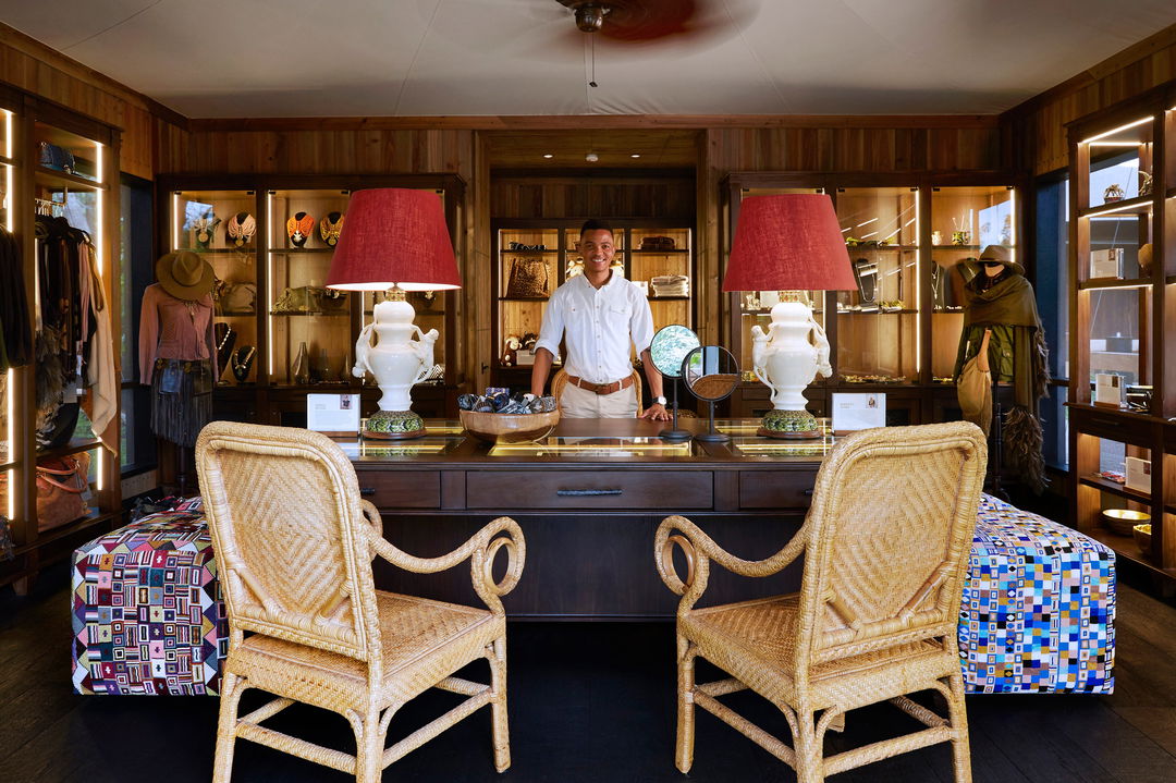 Reception staff in safari boutique shop area at Xigera safari lodge Botswana