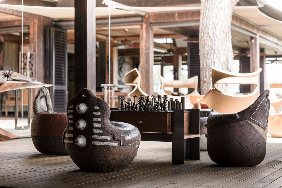 African art chairs with designer African custom chess board on table a Xigera lodge
