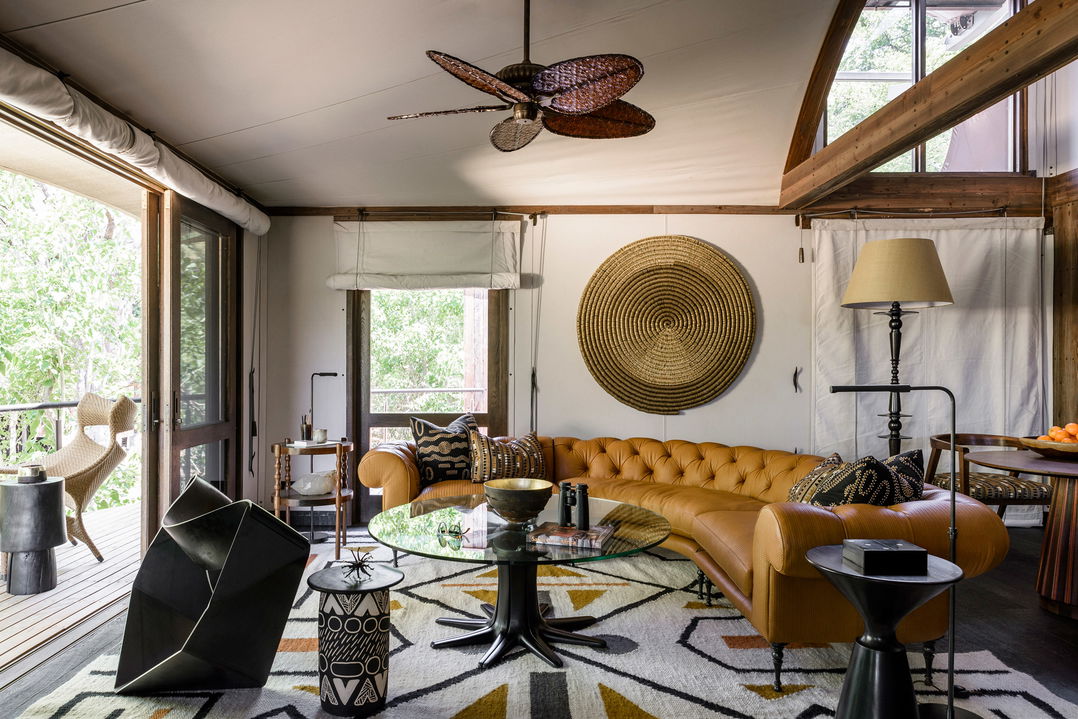 Main lounge area of Xigera safari lodge with sofas and leather chairs