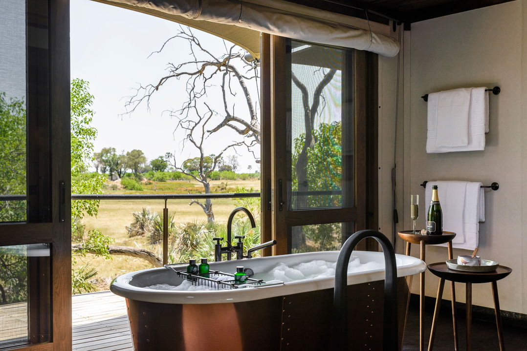 bathtub in bathroom with a delta view at Xigera Lodge Botswana