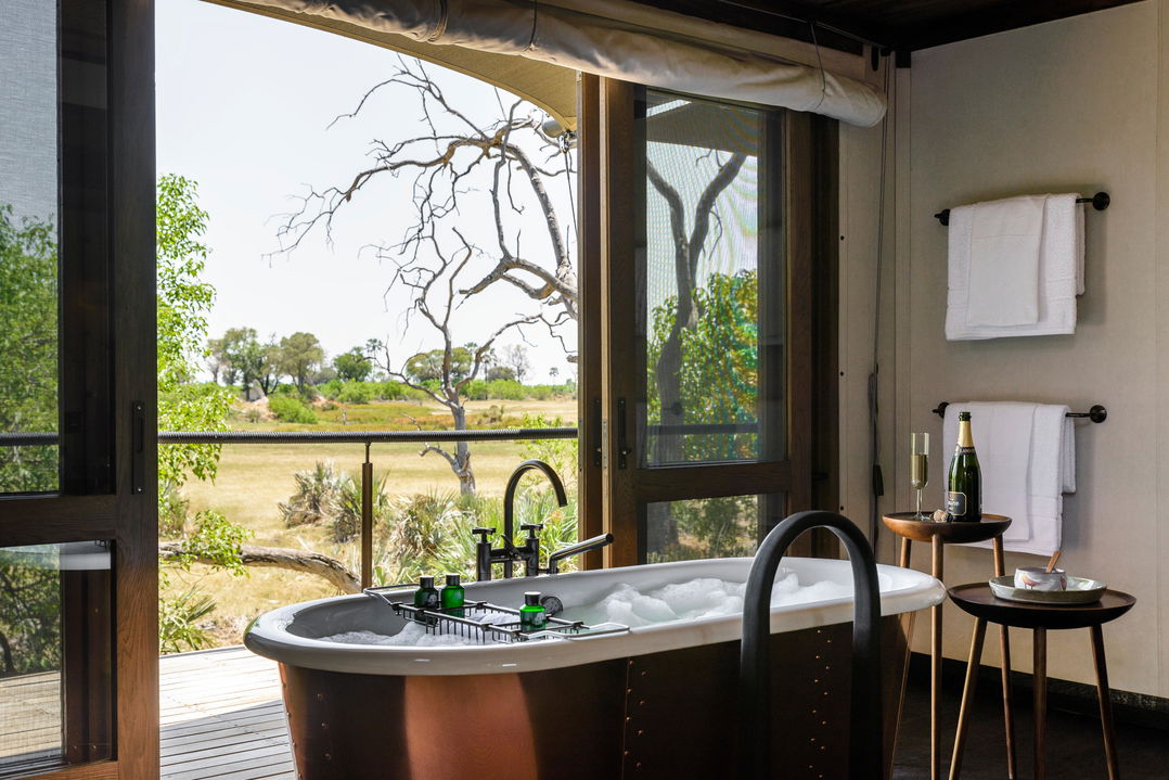 bath with open view of Okavango delta at Xigera lodge
