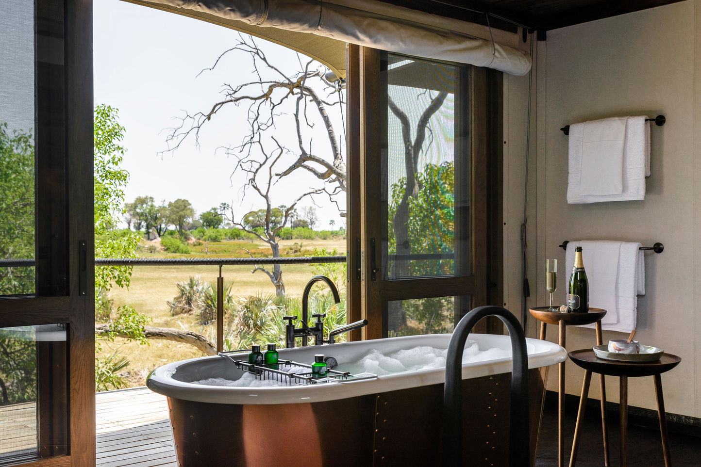 bath with open view of Okavango delta at Xigera lodge
