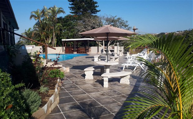 Pool deck with Cabanas 1,2 and 3 on the left and the pool dry bar and BBQ facilities to the right