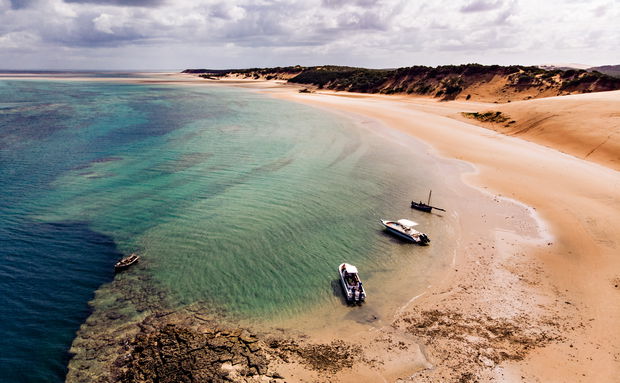 Drone view of Archipelago Island with boats in shallow water
