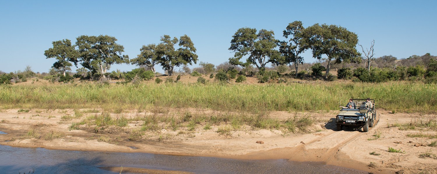 A safari game vehicle crossing the river in the Greater Kruger at Klaserie Drift